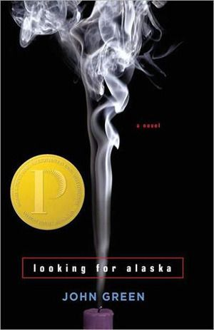 The cover of Looking For Alaska by John Green; a black cover with smoke rising up from a candle on it.